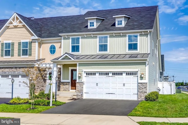 townhome / multi-family property featuring a garage and a front lawn