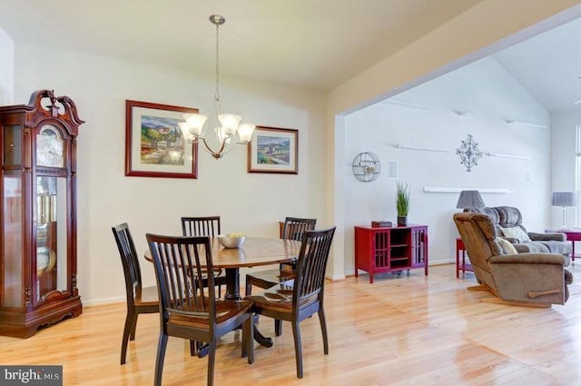 dining room with an inviting chandelier and light hardwood / wood-style flooring