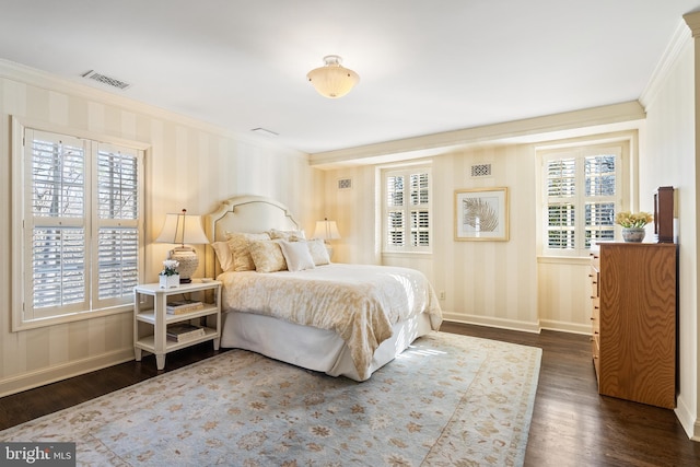 bedroom featuring ornamental molding, visible vents, dark wood finished floors, and baseboards