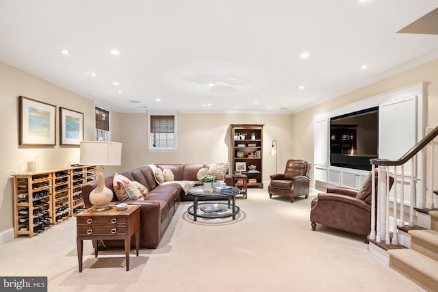 living room featuring carpet, stairway, and ornamental molding