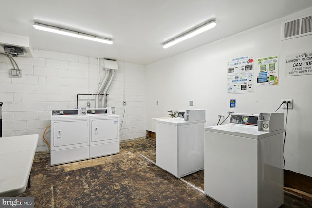 clothes washing area featuring washer and clothes dryer