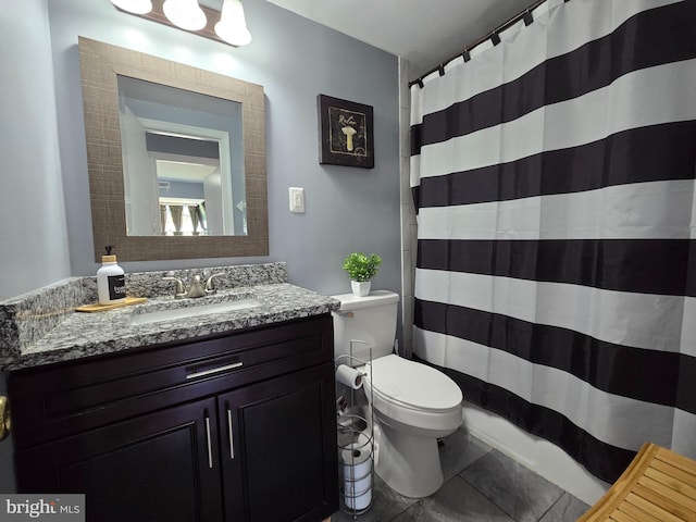 bathroom with curtained shower, vanity, and toilet