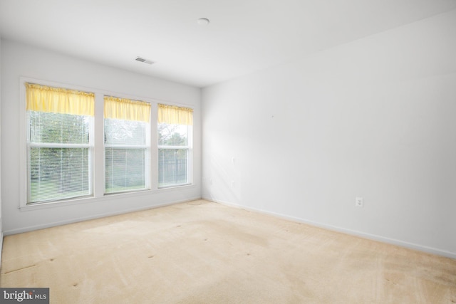 unfurnished room with light carpet