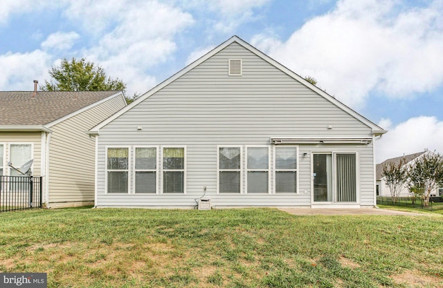 rear view of house with a yard and a patio