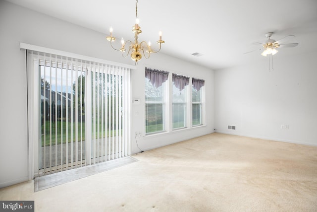 carpeted empty room featuring ceiling fan with notable chandelier