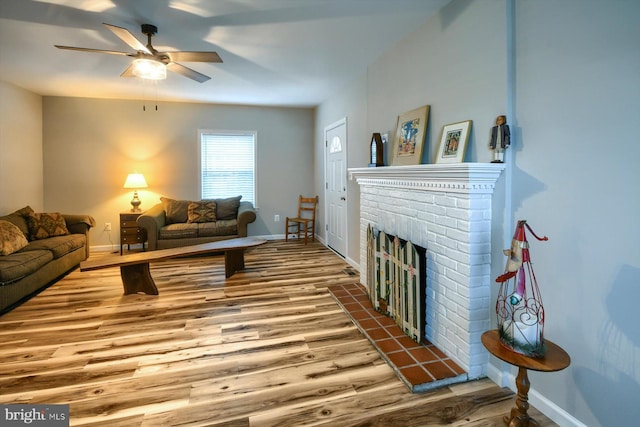 living room with hardwood / wood-style flooring, ceiling fan, and a fireplace