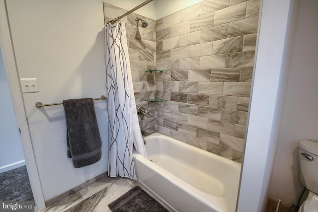 bathroom featuring shower / tub combo and toilet