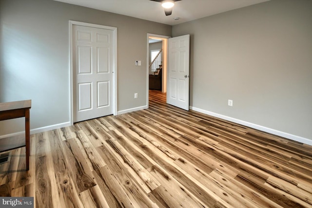 unfurnished bedroom featuring ceiling fan and light wood-type flooring