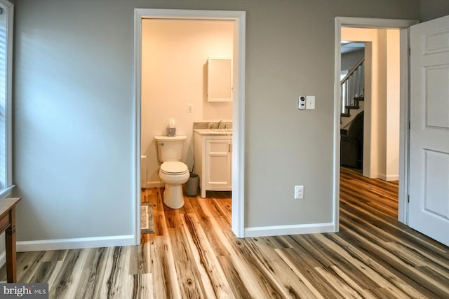 bathroom featuring hardwood / wood-style flooring, vanity, and toilet