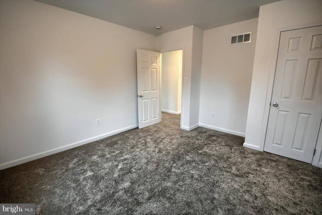 unfurnished bedroom featuring dark colored carpet