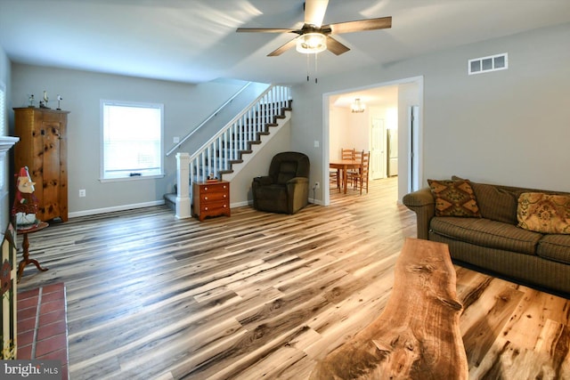 living room featuring hardwood / wood-style flooring and ceiling fan