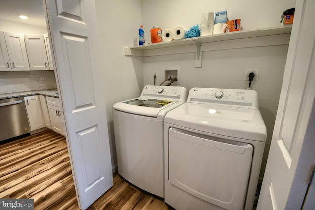 laundry area with washing machine and clothes dryer and dark hardwood / wood-style floors