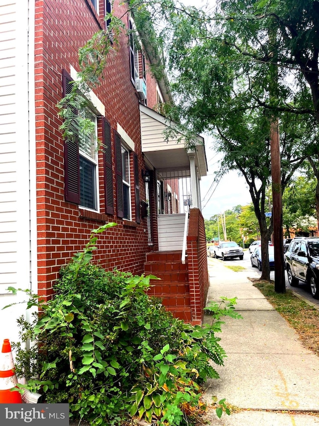 view of side of home featuring cooling unit