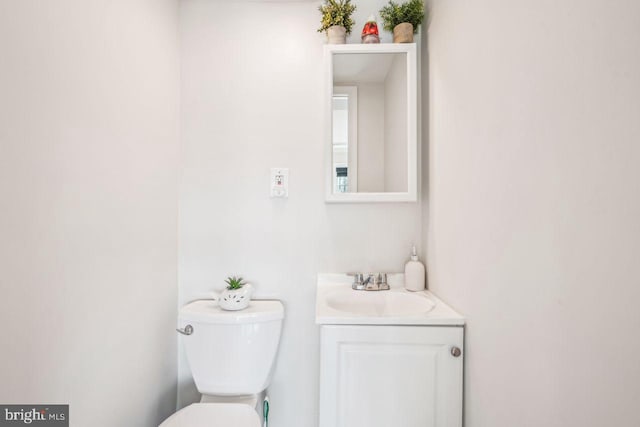 bathroom featuring toilet and vanity