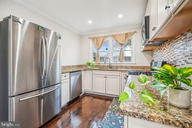 kitchen featuring dark hardwood / wood-style flooring, sink, white cabinets, light stone countertops, and stainless steel appliances