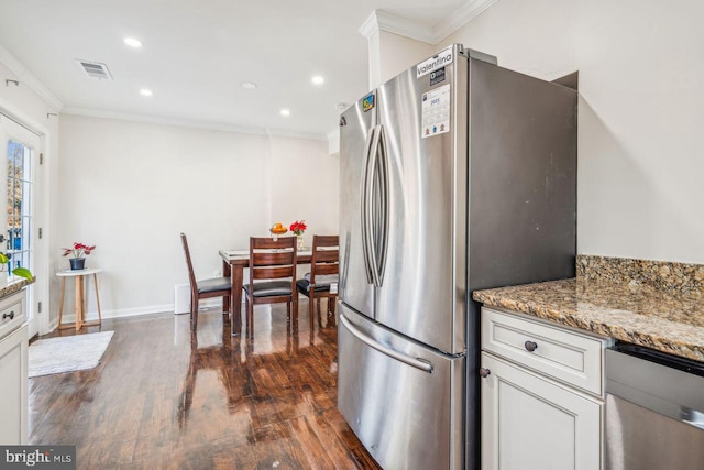 kitchen with white cabinetry, crown molding, stone countertops, and stainless steel fridge