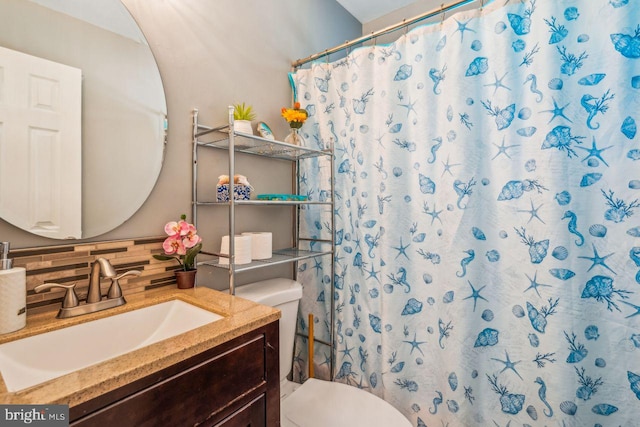 bathroom featuring curtained shower, backsplash, toilet, and vanity