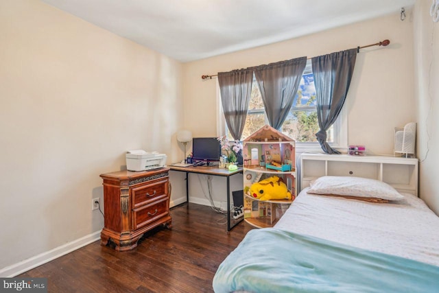 bedroom with dark hardwood / wood-style flooring