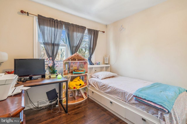 bedroom with dark hardwood / wood-style flooring