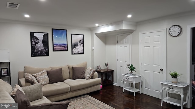 living room featuring dark hardwood / wood-style flooring and ornamental molding