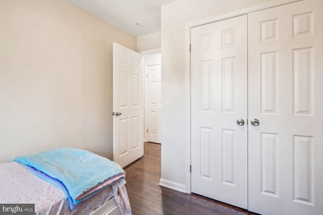 bedroom with a closet and dark hardwood / wood-style flooring