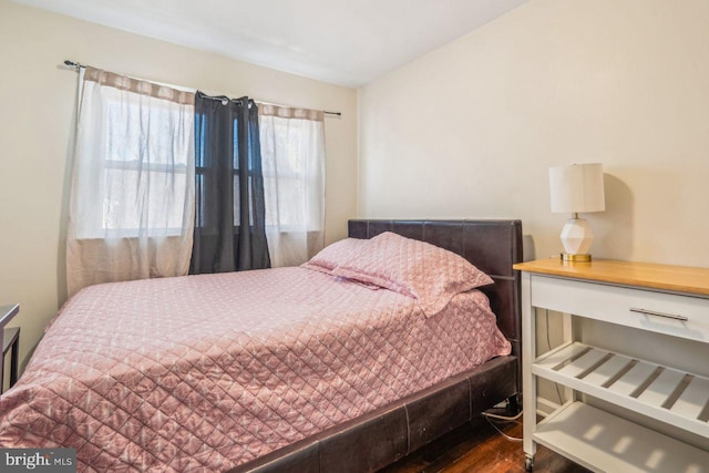 bedroom with dark hardwood / wood-style floors