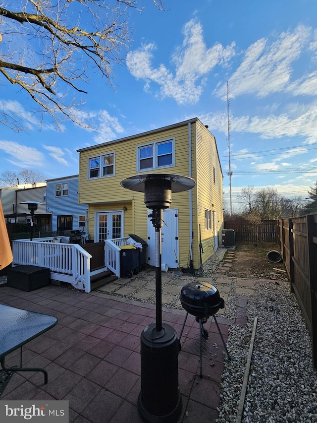 back of house featuring central AC unit, a patio area, a wooden deck, and french doors