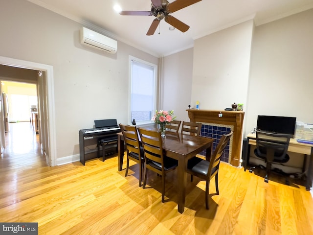 dining area featuring ceiling fan, light hardwood / wood-style floors, an AC wall unit, and ornamental molding