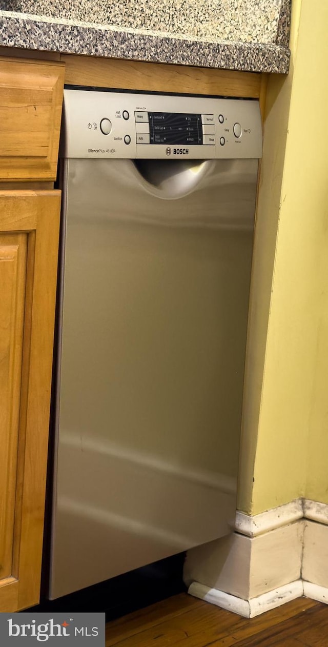 room details featuring dishwasher and wood-type flooring