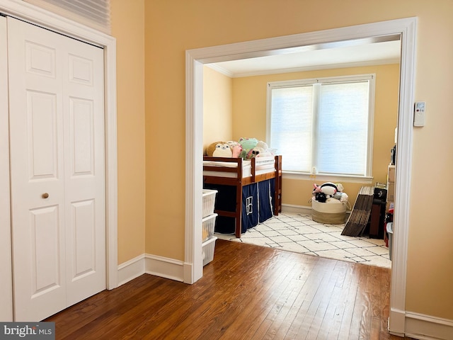 interior space with crown molding and wood-type flooring