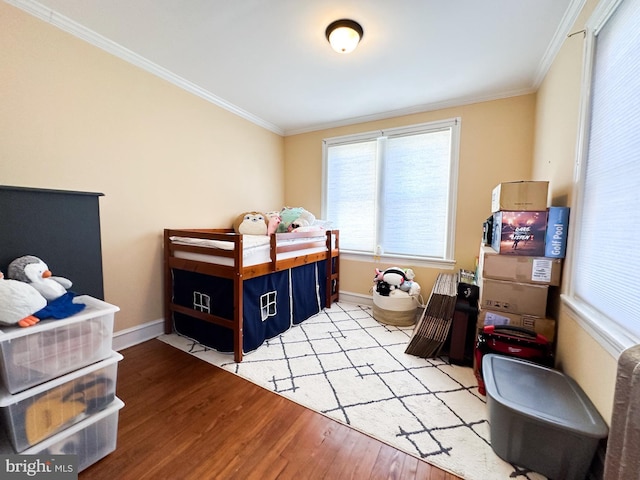 bedroom featuring light hardwood / wood-style flooring and crown molding