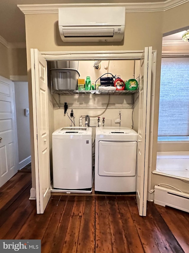 washroom with a wall mounted air conditioner, a baseboard heating unit, crown molding, dark hardwood / wood-style floors, and washing machine and clothes dryer