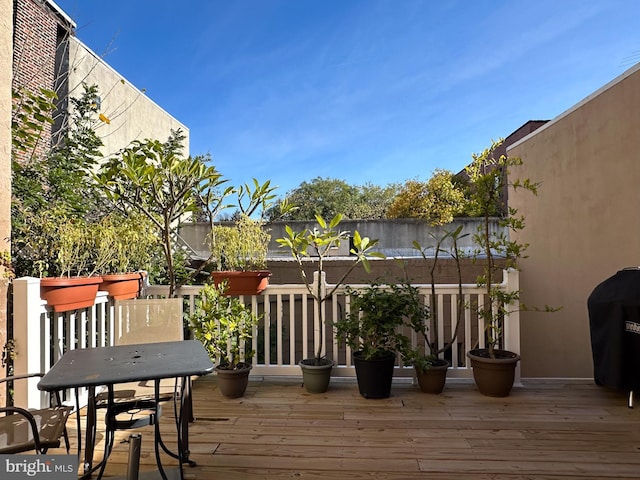 wooden terrace featuring area for grilling