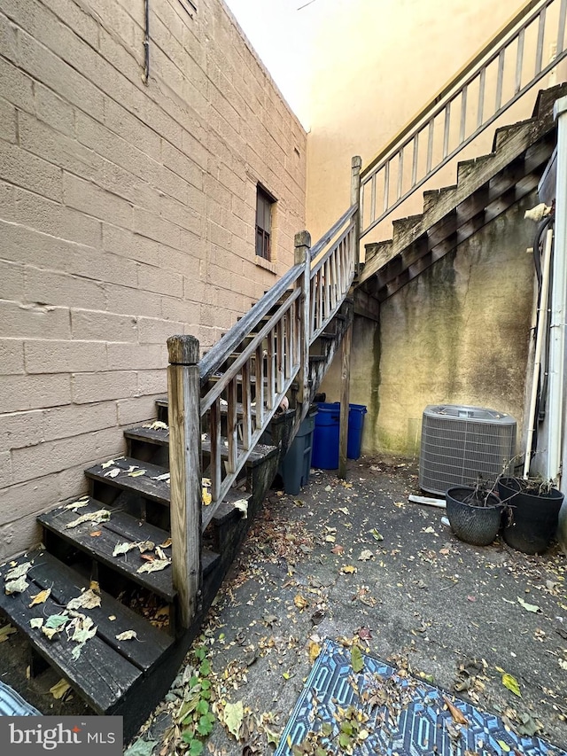 view of side of home with central AC unit