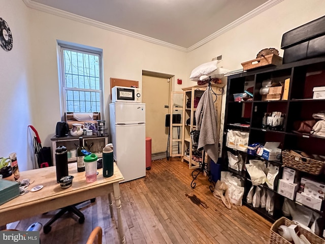 interior space featuring hardwood / wood-style floors and crown molding