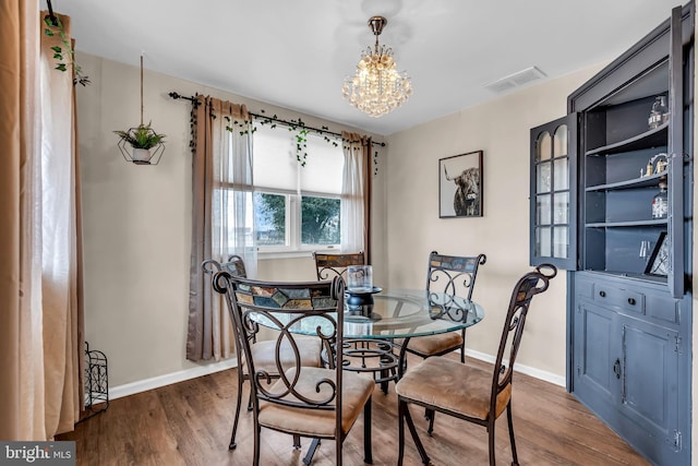 dining room featuring an inviting chandelier and hardwood / wood-style floors