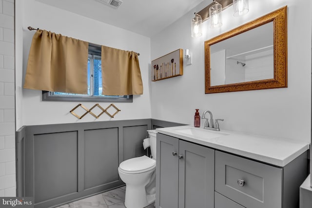 bathroom featuring toilet and vanity