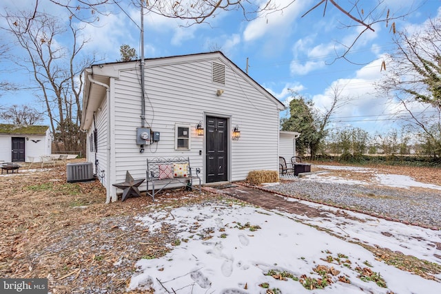 snow covered property featuring central air condition unit