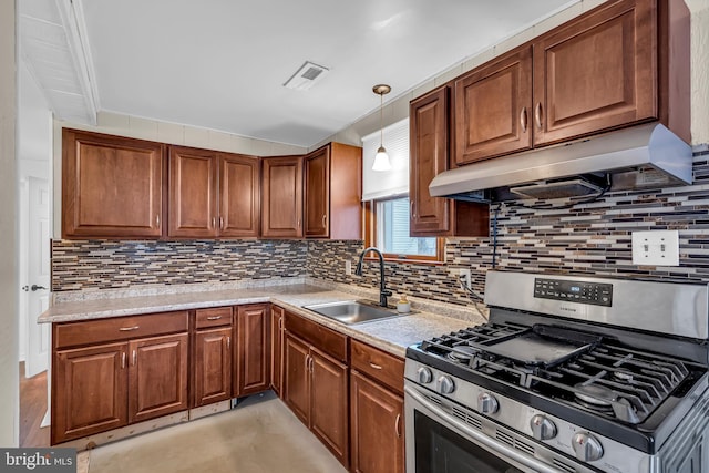 kitchen featuring extractor fan, stainless steel range with gas cooktop, pendant lighting, decorative backsplash, and sink