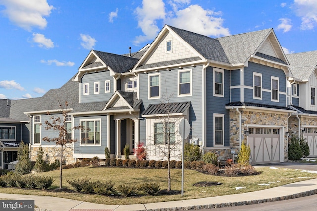 view of front of home featuring a garage and a front yard