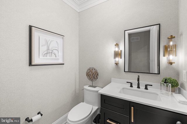 bathroom featuring crown molding, vanity, and toilet