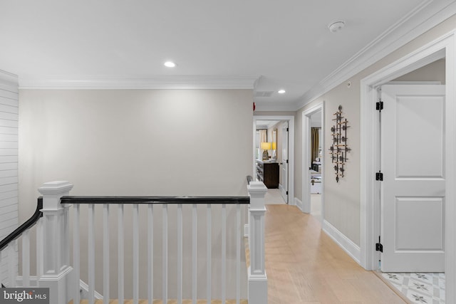 hall with crown molding and light hardwood / wood-style flooring