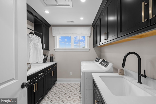 laundry area featuring sink, cabinets, and washing machine and clothes dryer