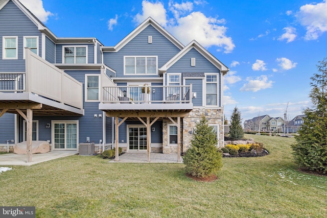 rear view of property featuring a patio area, central air condition unit, and a lawn