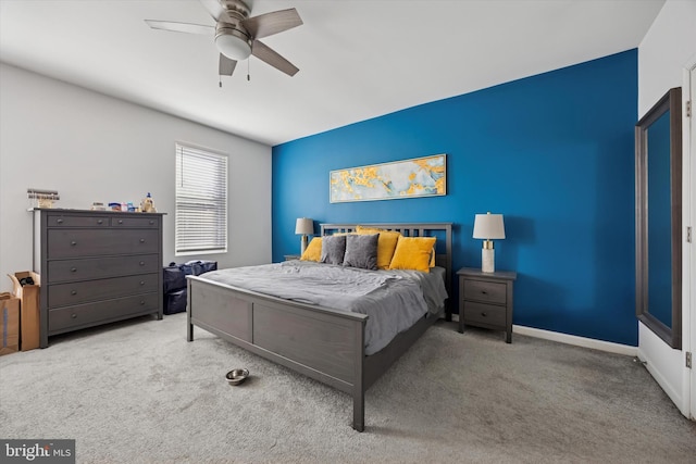 carpeted bedroom with a ceiling fan and baseboards