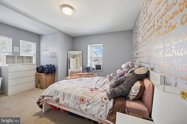 bedroom featuring carpet and multiple windows