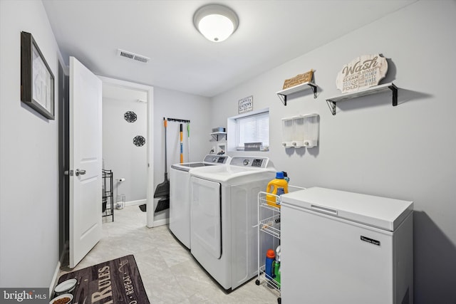 laundry room featuring laundry area, separate washer and dryer, and visible vents