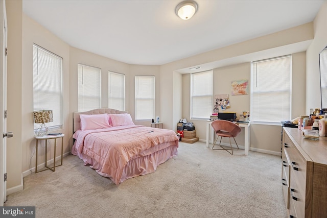 carpeted bedroom featuring baseboards