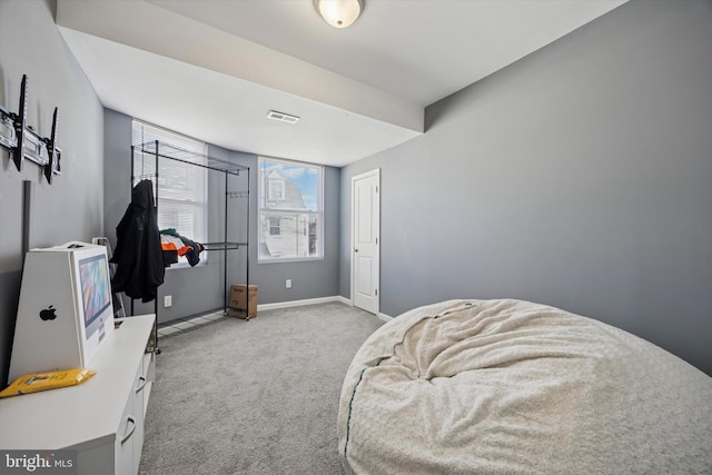 bedroom with baseboards, visible vents, and light colored carpet