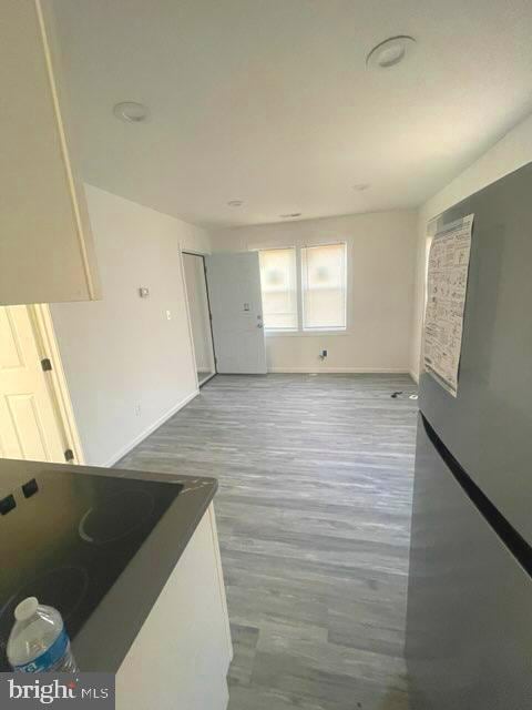 unfurnished living room featuring hardwood / wood-style flooring